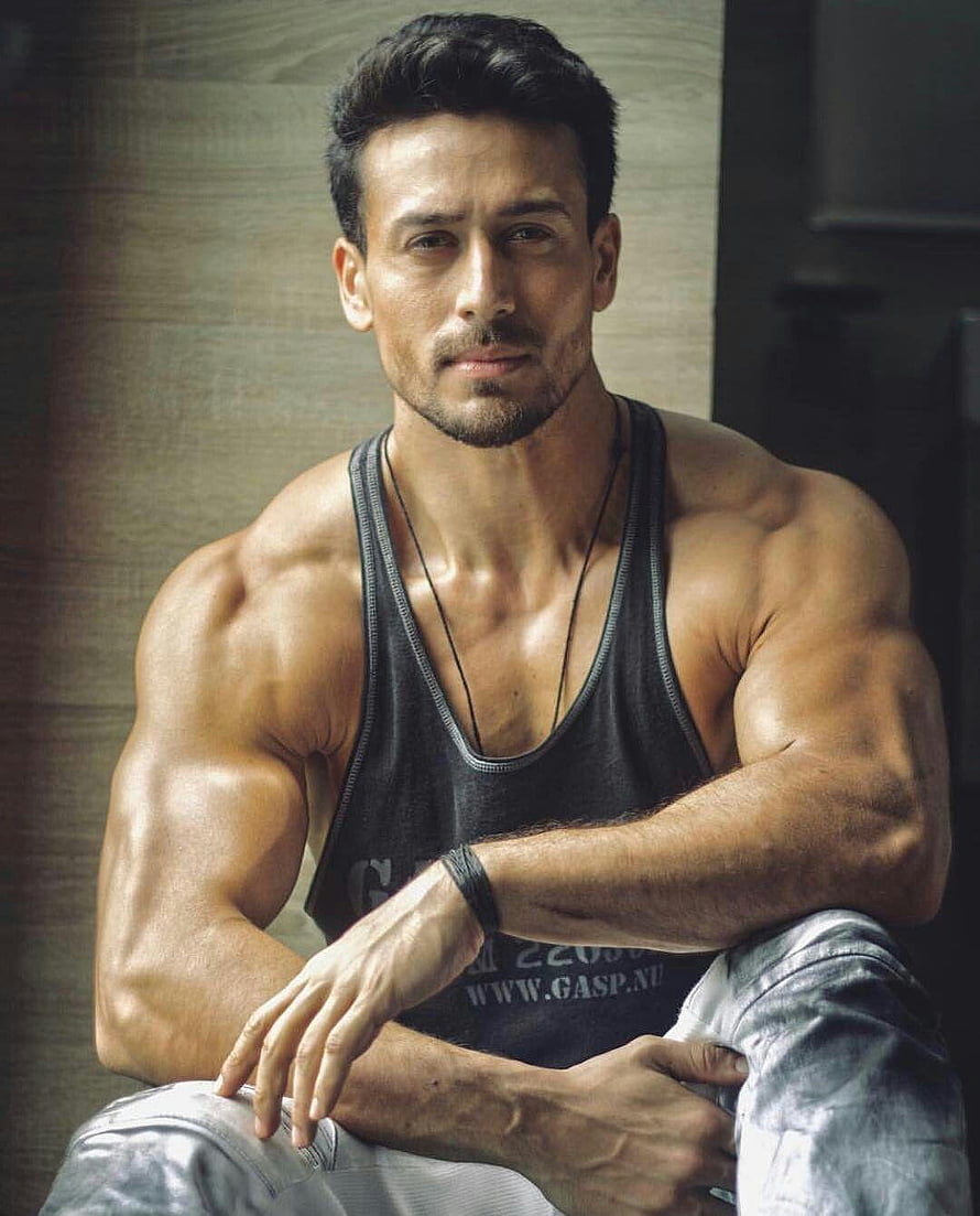 Tiger Shroff Muscular Portrait in Black Tank Top and Grey Jeans HD phone wallpaper