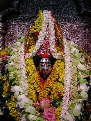 Maa Tara Divine Idol Adorned With Vibrant Flower Garlands and Traditional Temple Decorations HD phone wallpaper