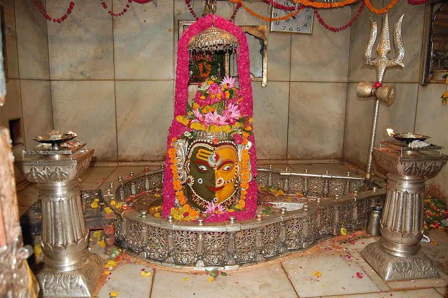 Mahakaleshwar Jyotirlinga shrine adorned with vibrant floral garlands and traditional temple offerings HD wallpaper