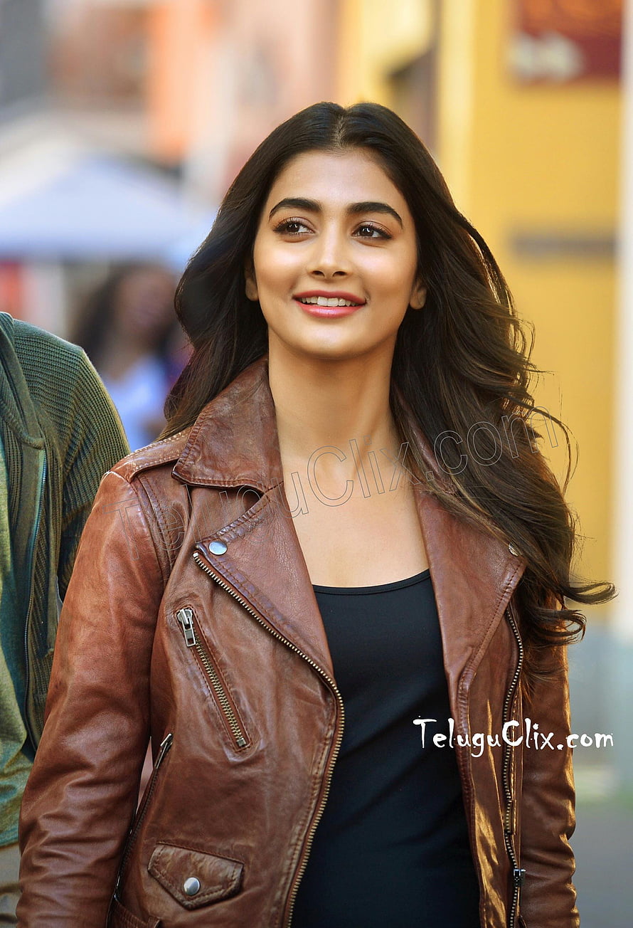 Pooja Hegde in a brown leather jacket and black top with long wavy hair HD phone wallpaper