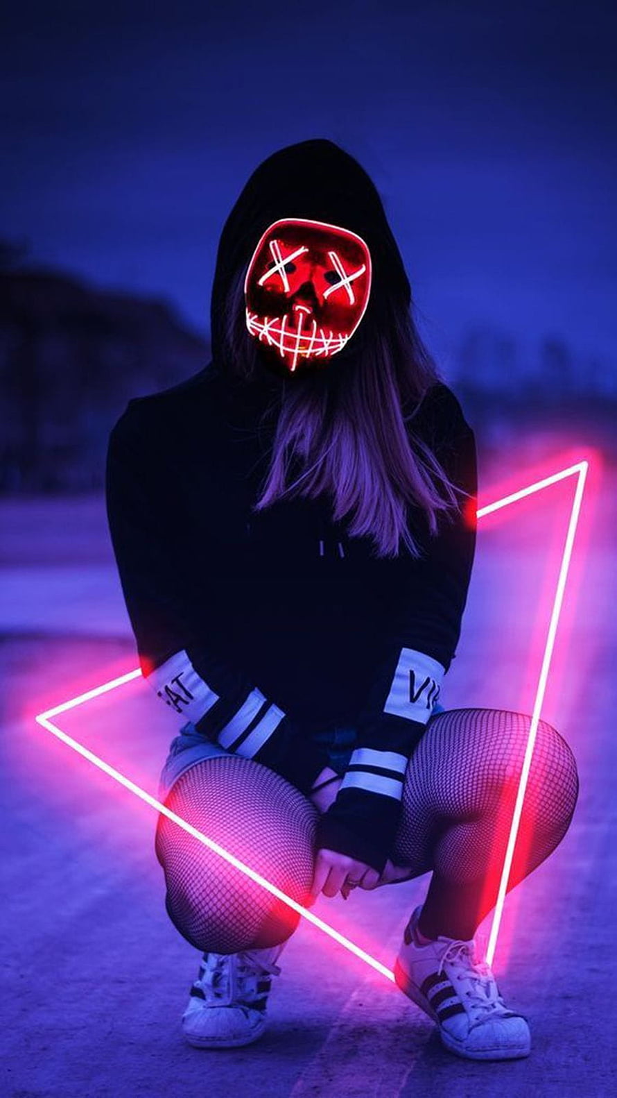 Woman in black hoodie wearing a glowing red LED skull mask with neon pink triangle light HD phone wallpaper