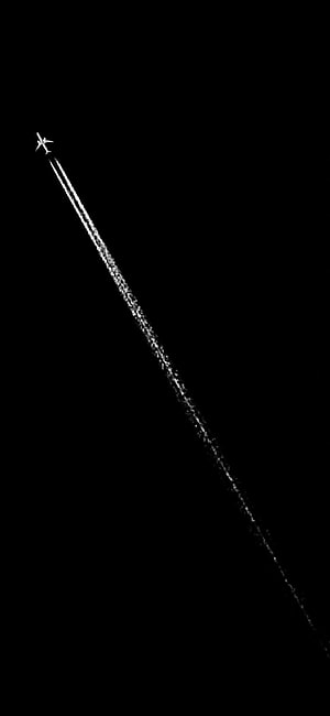 Minimalist Airplane Silhouette with Contrail Against Pure Black Sky HD phone wallpaper