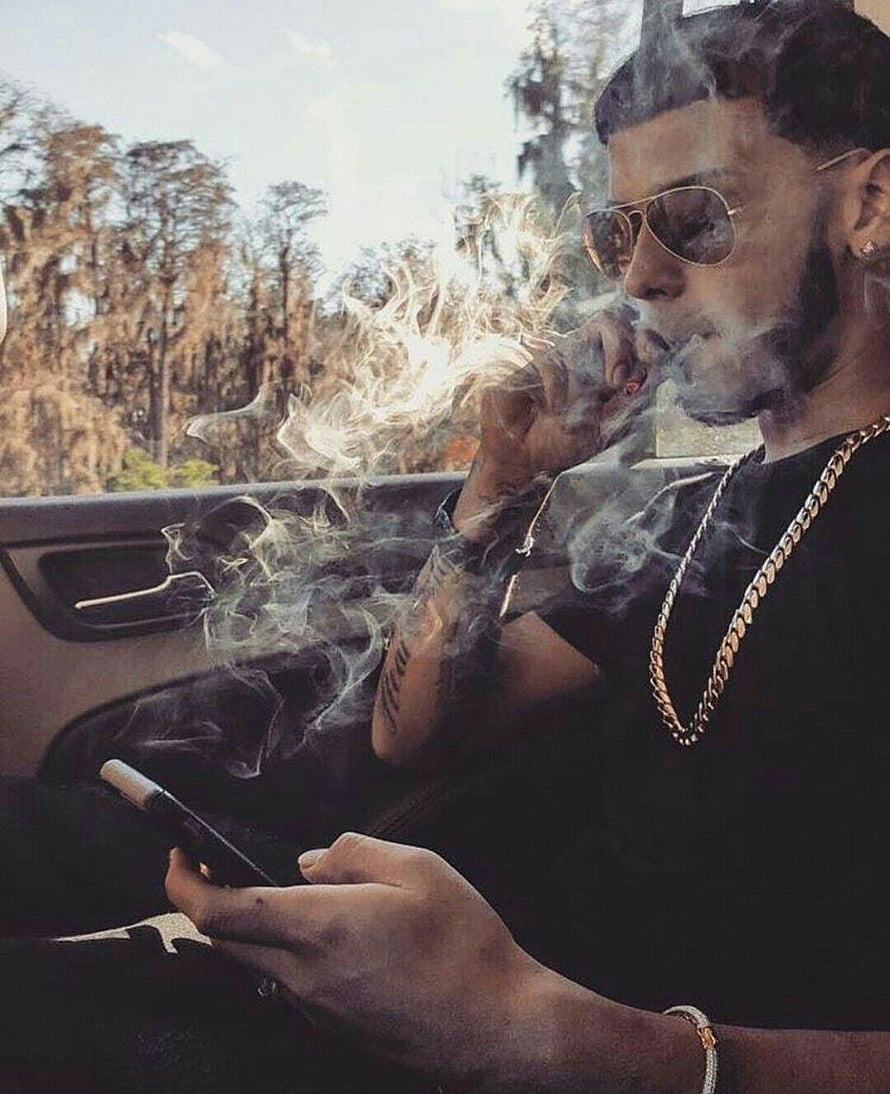 Anuel AA Smoking Cigar in Car with Gold Chain and Aviator Sunglasses HD phone wallpaper