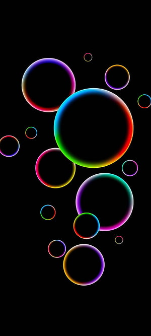 Vibrant Neon Bubble Rings Floating on a Deep Black Background HD phone wallpaper