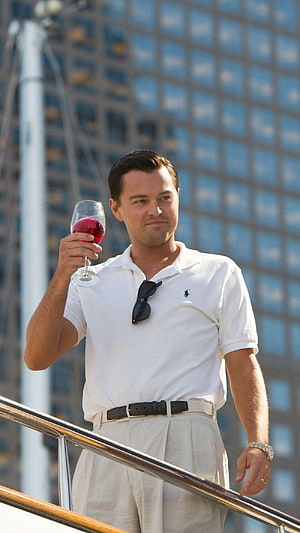 Leonardo DiCaprio as Jordan Belfort in The Wolf of Wall Street Holding a Glass of Red Wine on a Yacht Deck HD phone wallpaper