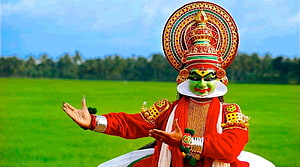 Traditional Kathakali Dancer in Vibrant Red Costume and Elaborate Headdress HD wallpaper