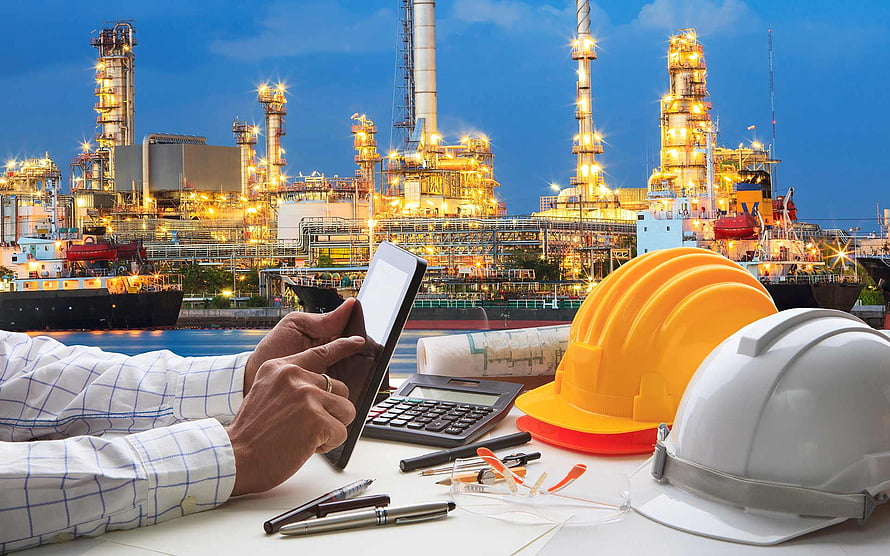 Oil and Gas Industry Engineering Workspace with Hard Hats and Tablet HD wallpaper