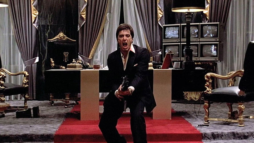 Tony Montana in Scarface Holding a Gun in an Ornate Office HD wallpaper