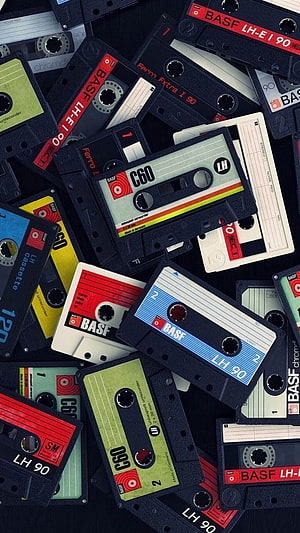 Retro BASF C60 and LH90 Audio Cassettes Scattered on Dark Background HD phone wallpaper