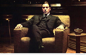 Al Pacino as Michael Corleone in The Godfather seated in a dark armchair HD wallpaper
