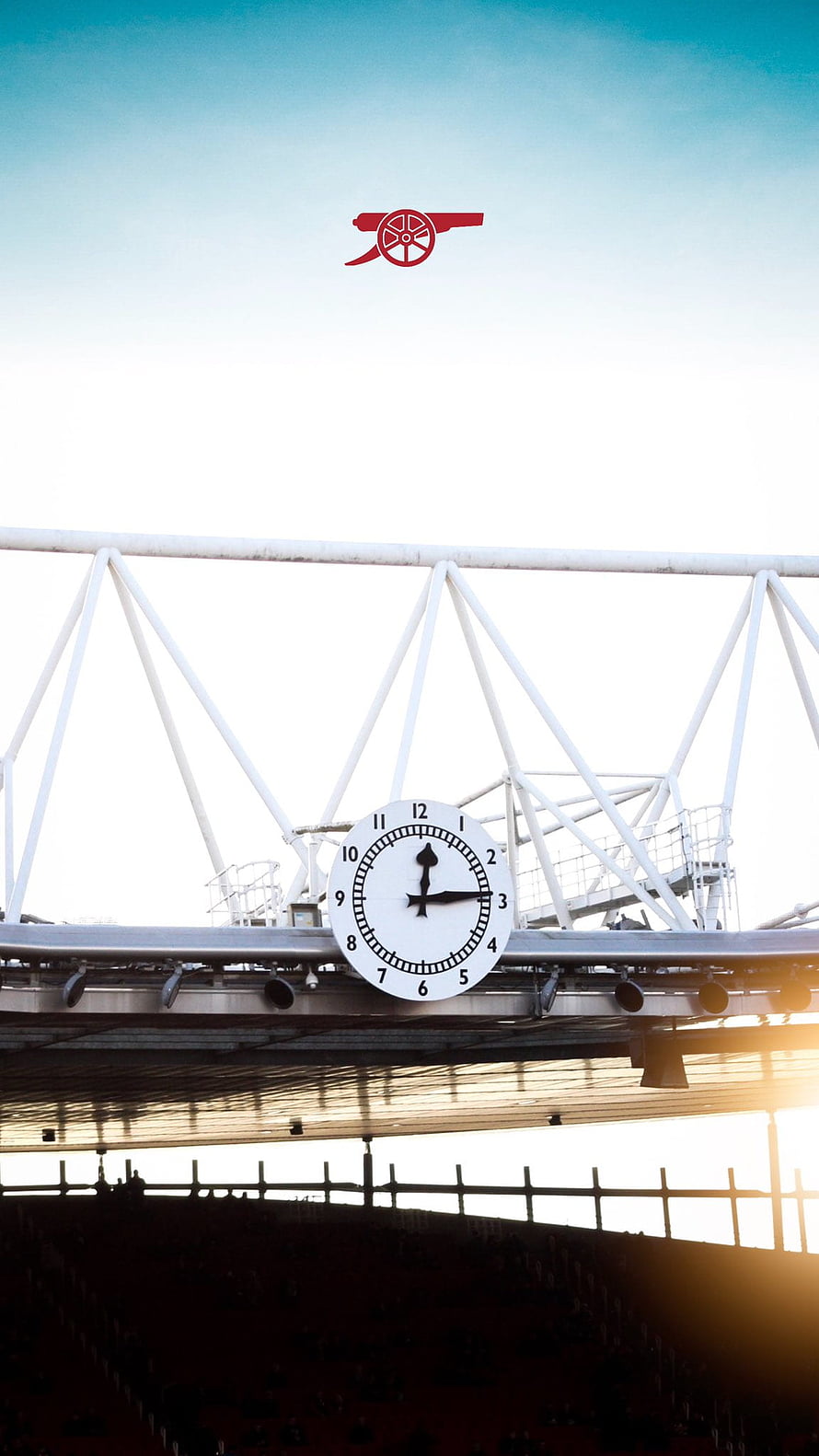Arsenal Stadium Clock and Cannon Logo Against a Bright Sky HD phone wallpaper