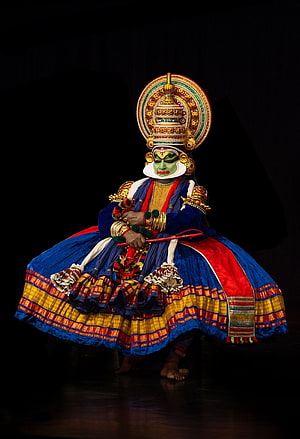 Kathakali Performer in Traditional Kerala Attire with Elaborate Headdress and Green Face Paint HD phone wallpaper