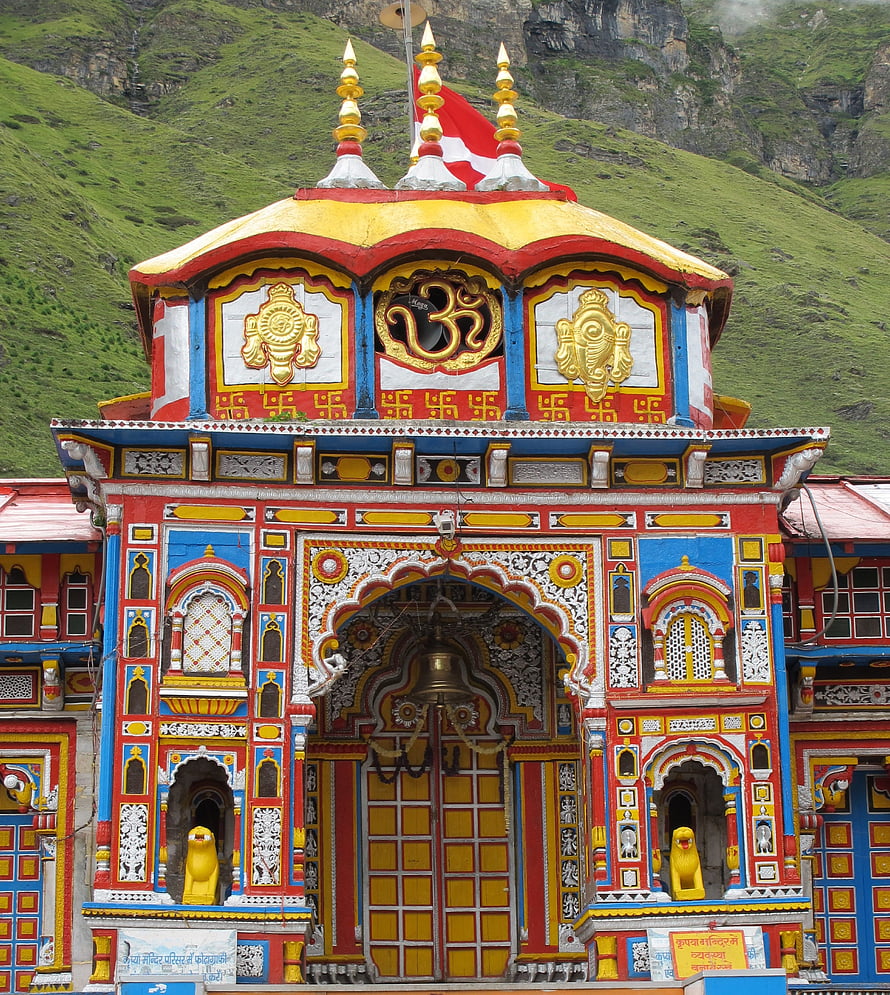 Badrinath Temple Facade with Golden Om Symbol and Vibrant Himalayan Mountain Backdrop HD phone wallpaper