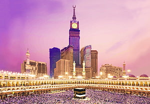 Abraj Al Bait Clock Tower and Kaaba in Mecca at Dusk with Pilgrims HD wallpaper