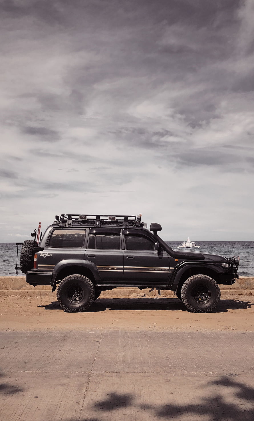 Black Toyota Land Cruiser 79 Series VX Limited Off-Road SUV Parked by the Sea HD phone wallpaper