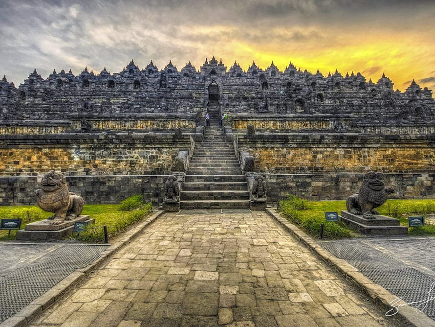Borobudur Temple at Golden Hour with Stone Lion Guardians and Dramatic Sky HD wallpaper