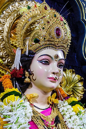 Ornate Durga Murti Adorned With Jewels, Flowers, and Traditional Indian Temple Decor HD phone wallpaper