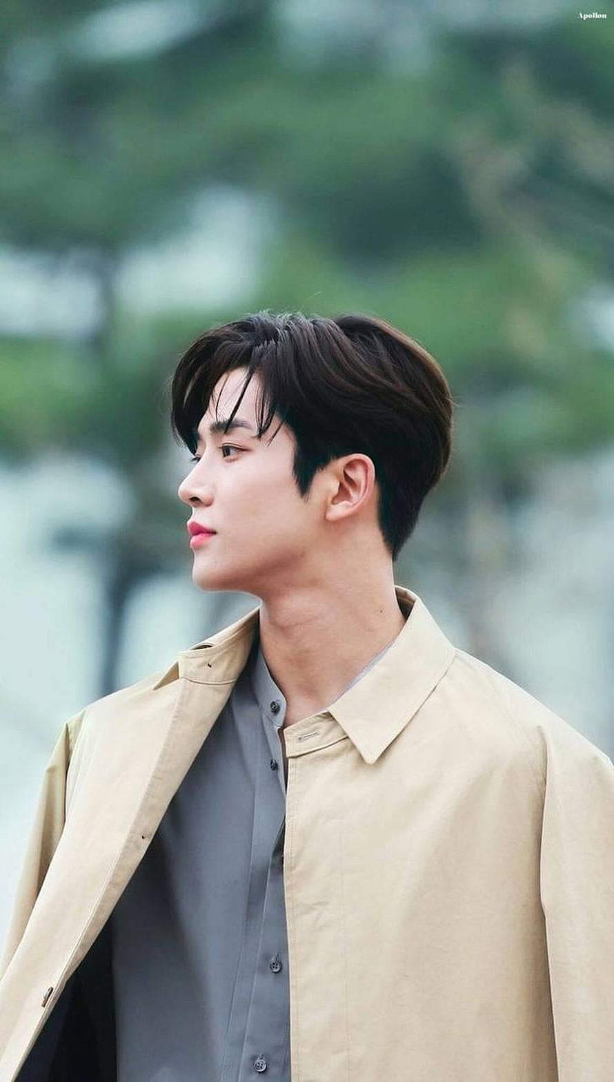 Kim Rowoon from SF9 in a beige trench coat and grey shirt with a soft outdoor background HD phone wallpaper