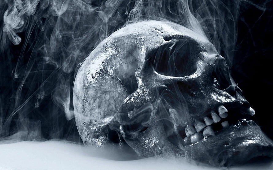 Moody Human Skull in Swirling Smoke with Dark Atmospheric Lighting HD wallpaper