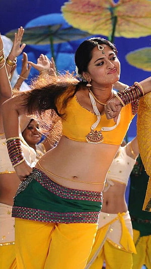 Anushka Shetty in Vibrant Yellow and Green Traditional Dance Costume HD phone wallpaper
