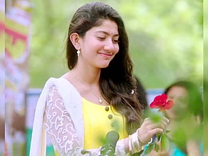 Sai Pallavi in Yellow Dress Holding Red Rose in Garden HD wallpaper