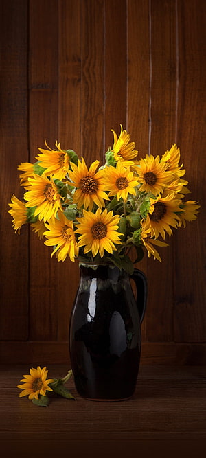 Vibrant Sunflower Bouquet in a Dark Ceramic Vase Against a Rustic Wooden Background HD phone wallpaper