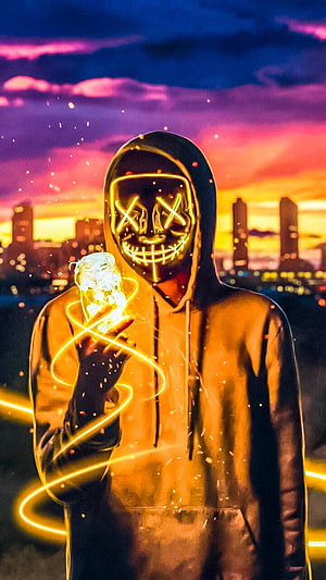 Hacker in Glowing Neon Mask Holding Electric Orb Against Vibrant City Skyline HD phone wallpaper