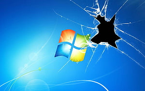 Windows 7 Logo on Cracked Blue Glass Screen with Shattered Impact Hole HD wallpaper