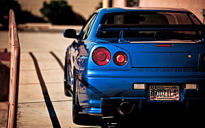 Rear View of a Blue Nissan Skyline GT-R R34 with Arizona Plate HD wallpaper