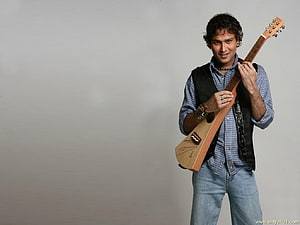 Zubeen Garg Holding Acoustic Guitar in Studio Portrait HD wallpaper