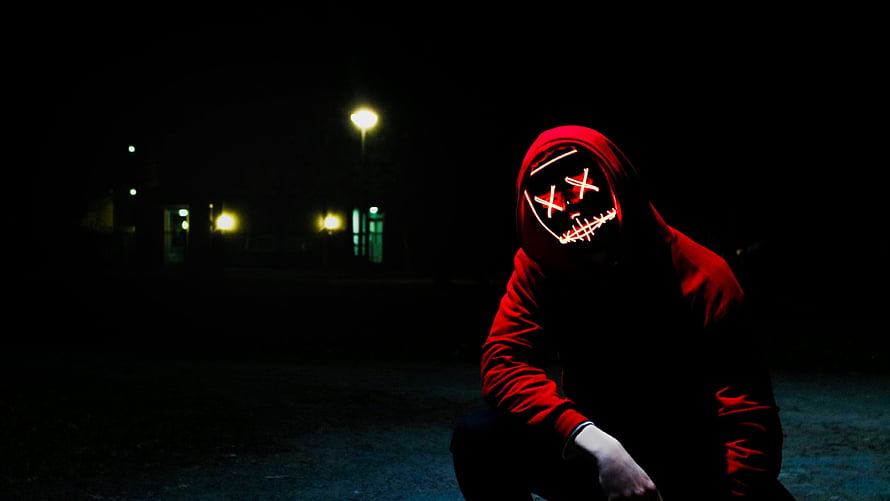 Man in Red Hoodie Wearing Glowing LED Mask at Night HD wallpaper
