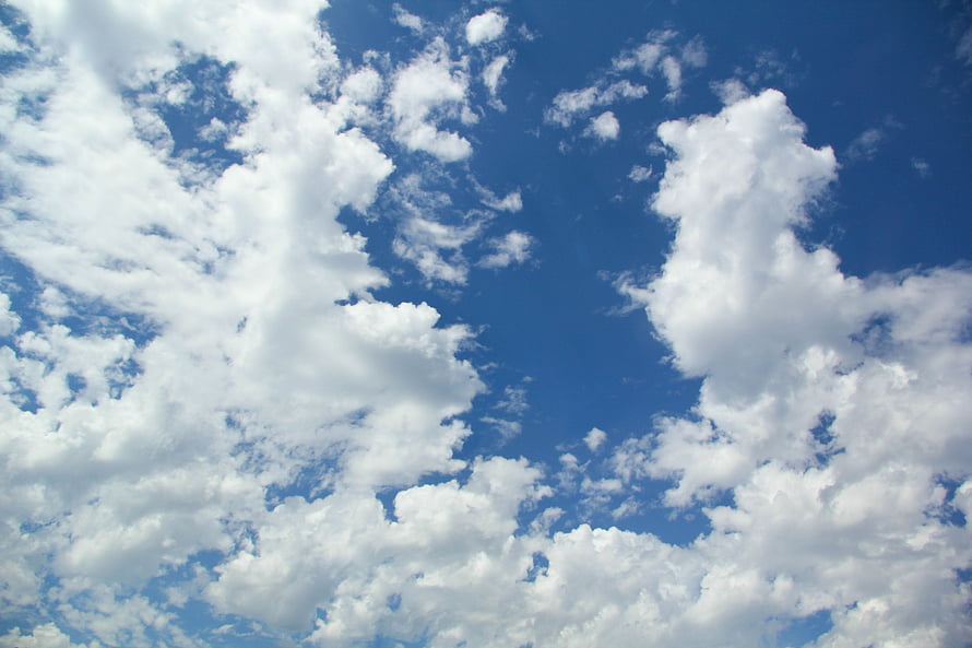 Bright Blue Sky With Fluffy White Cumulus Clouds On A Sunny Day HD wallpaper