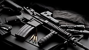 M4A1 Carbine with Tactical Accessories, Ammunition, and Gloves on Dark Surface HD wallpaper