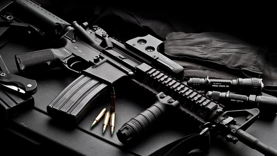 M4A1 Carbine with Tactical Accessories, Ammunition, and Gloves on Dark Surface HD wallpaper
