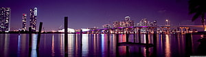 Panoramic Night View of Miami Skyline with Biscayne Bay Waterfront and Bridge Reflections HD wallpaper