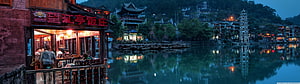 Fenghuang Ancient Town Riverside at Dusk with Traditional Chinese Architecture and Lanterns HD wallpaper