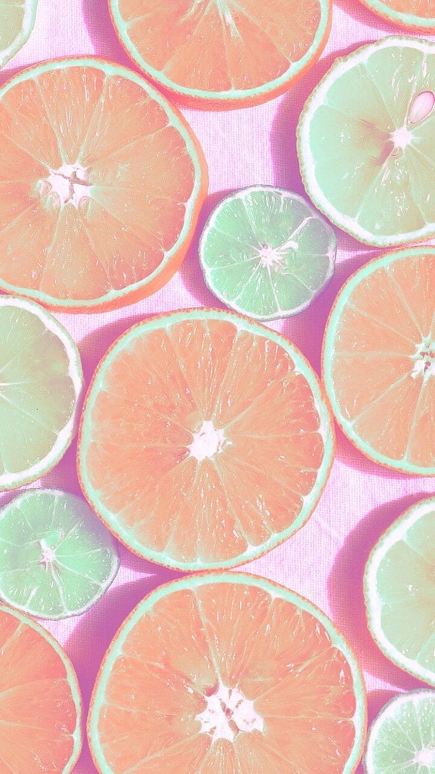 Pastel citrus fruit slices arranged on a soft pink background with dreamy aesthetic styling HD phone wallpaper