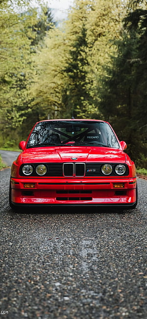 Red BMW E30 M3 Front View on Forest Road with Recaro Seats and Classic Grille Design HD phone wallpaper