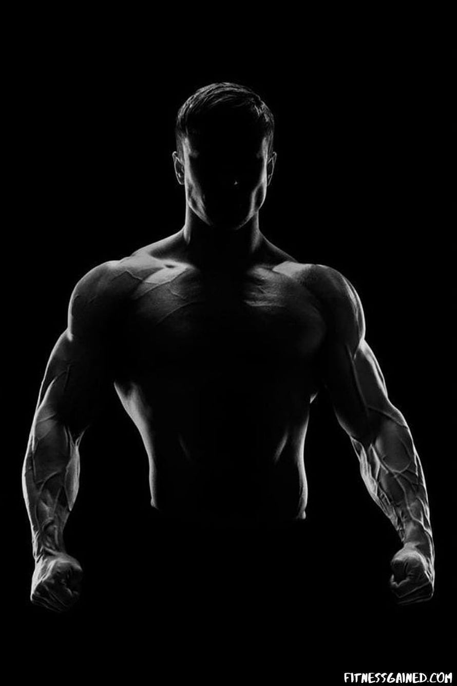 Dramatic Black and White Silhouette of a Muscular Male Athlete HD phone wallpaper