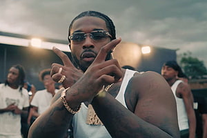 Pop Smoke in White Tank Top and Sunglasses Making Hand Gesture at Outdoor Event HD wallpaper