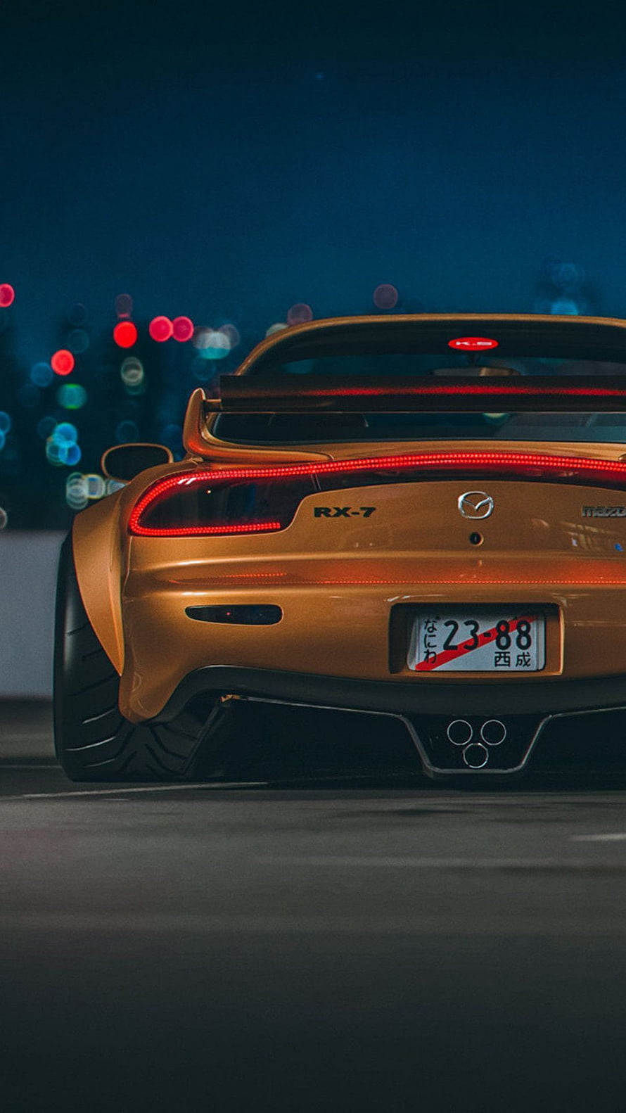 Rear View of a Gold Mazda RX-7 with LED Taillights and Night City Bokeh HD phone wallpaper