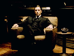 Michael Corleone seated in a dark armchair from The Godfather film HD wallpaper