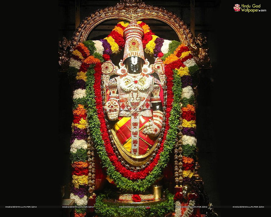 Lord Venkateswara Temple Idol Adorned With Vibrant Flower Garlands And Ornate Gold Crown HD wallpaper