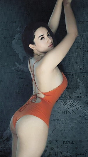 Aditi Budhathoki in Orange Bodysuit Against Vintage World Map Background HD phone wallpaper