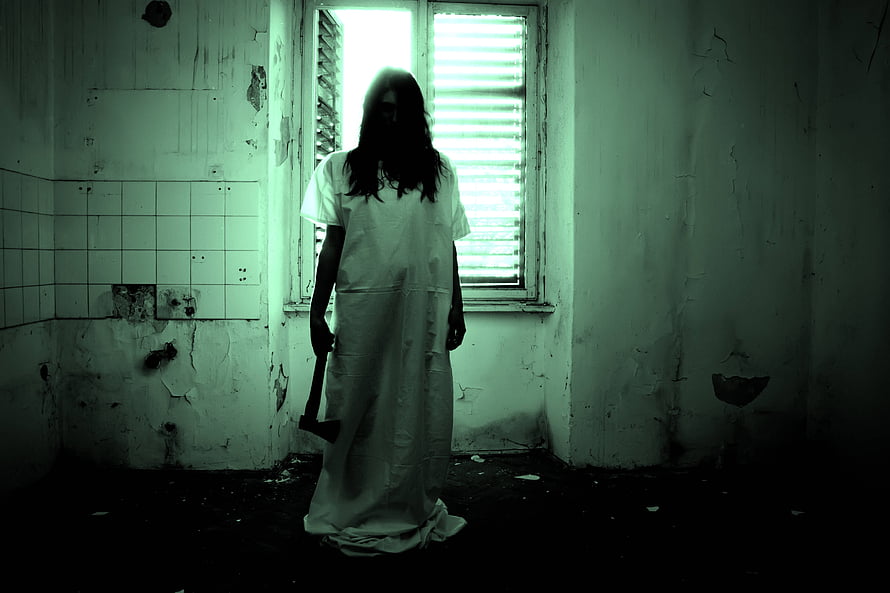 Eerie Silhouette of a Woman in a White Dress Holding an Axe in a Decaying Room HD wallpaper