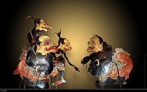 Traditional Indonesian Wayang Kulit Shadow Puppet Figures in Dramatic Confrontation HD wallpaper