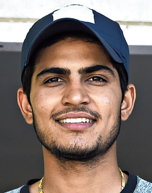 Shubman Gill smiling portrait wearing a navy blue baseball cap and gold chain necklace HD phone wallpaper