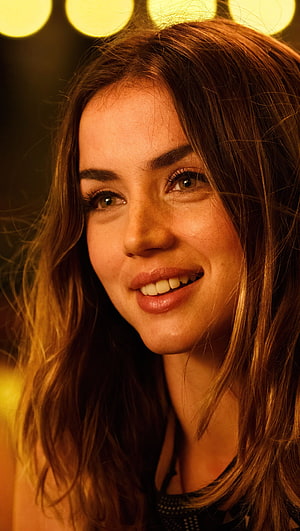 Ana de Armas Close-Up Portrait with Warm Golden Lighting and Soft Bokeh Background HD phone wallpaper