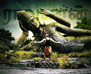 Raavanan Statue with Man Standing in River at Tamil Nadu Rock Formation HD wallpaper