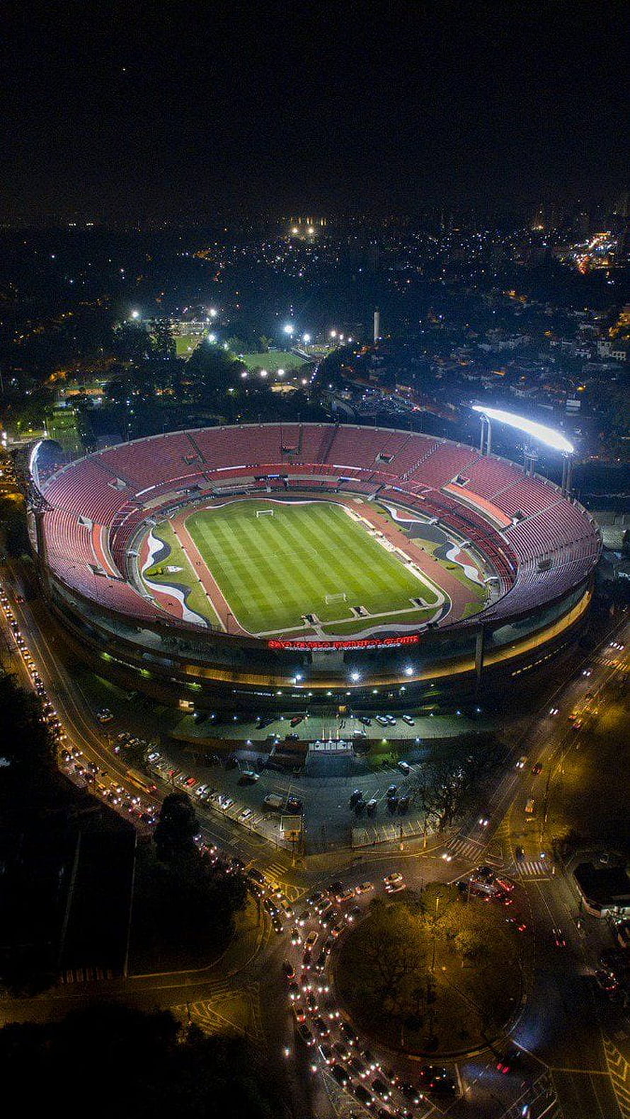 Aerial Night View of Morumbi Stadium in São Paulo with Illuminated Pitch and Surrounding City Lights HD phone wallpaper